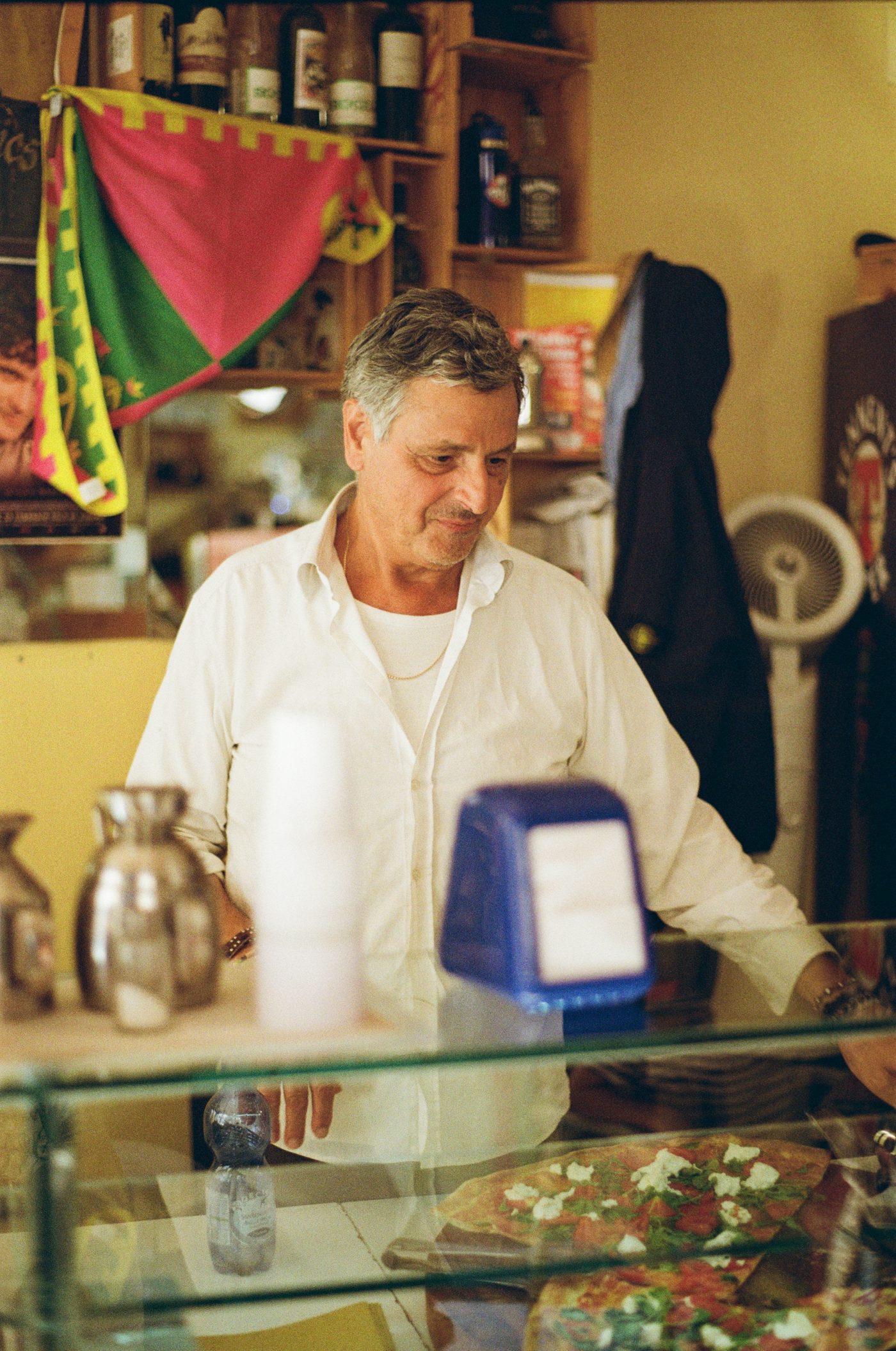 An owner behind the counter of a neighborhood spot